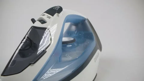 Device for smoothing clothes, electric Iron on a white background close-up Stock Footage 146045605