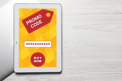 Devices on wooden table, flat lay with space for text. Activate promo code Stock Photos