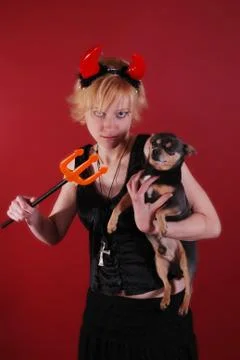 The Devil and the puppy Stock Photos