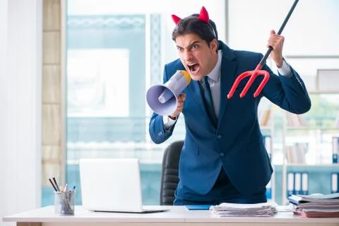 Devil angry businessman in the office Stock Photos