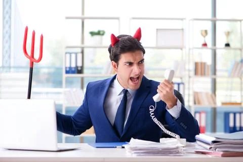 Devil angry businessman in the office Stock Photos