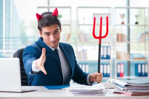 Devil angry businessman in the office Stock Photos