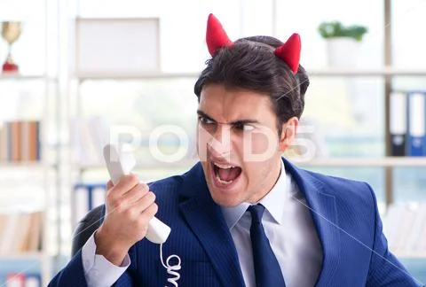 Devil angry businessman in the office Stock Photos
