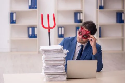Devil businessman and too much work in the office Stock Photos