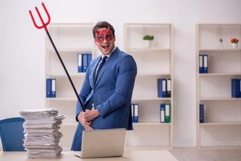 Devil businessman and too much work in the office Stock Photos