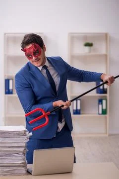 Devil businessman and too much work in the office Stock Photos