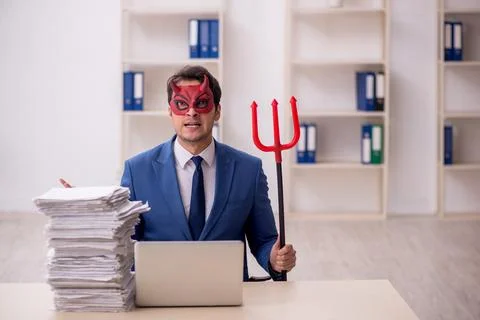 Devil businessman and too much work in the office Stock Photos
