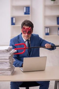 Devil businessman and too much work in the office Stock Photos
