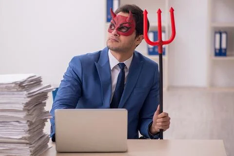 Devil businessman and too much work in the office Stock Photos