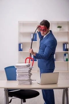 Devil businessman and too much work in the office Stock Photos