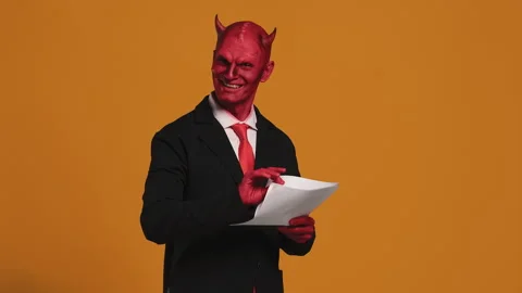 Devil businessman reading and writing on a document Stock Footage 294197509