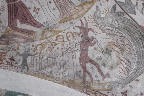 Devil drags people to the jaws of hell, an ancient mural Stock Photos