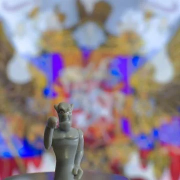 Devil figurine on blurred cinema screen background 스톡 사진