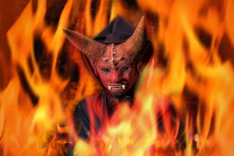 Devil on fire against a dark background Stock Photos