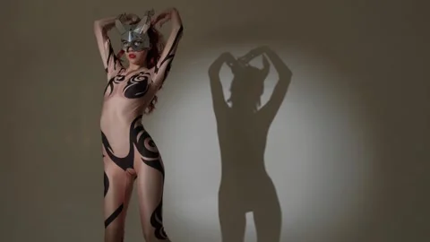 A devil girl with horns on her head in a sexy tight costume dances beautifully Stock Footage 260648958