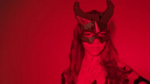 Devil girl with horns on her head in a sexy bodysuit in a red neon light studio. Stock Footage 270053699