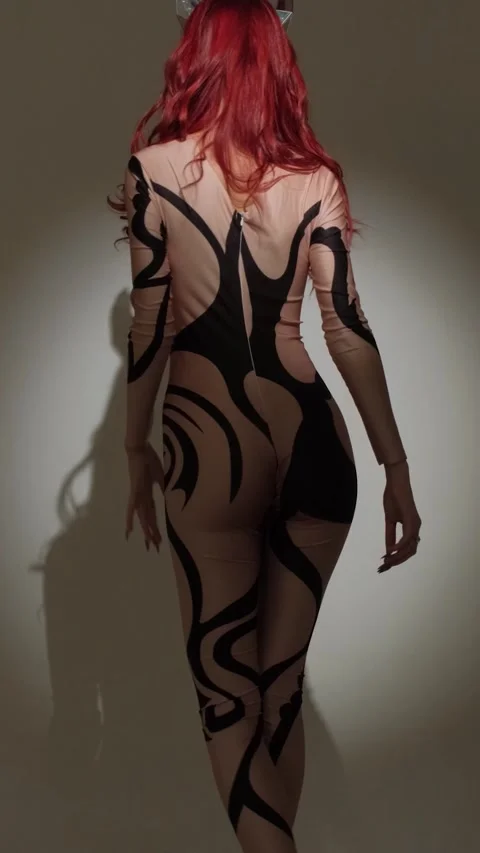 A devil girl with horns on her head in a sexy tight costume dances beautifully Stock Footage 274260099