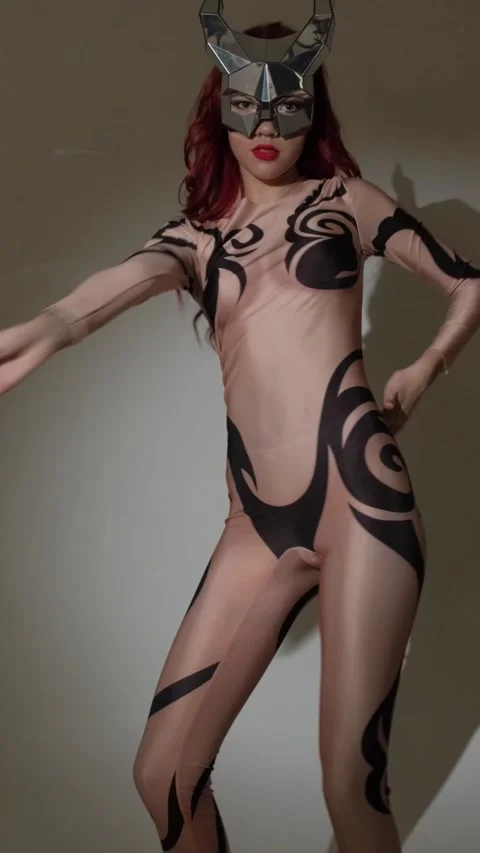 A devil girl with horns on her head in a sexy tight costume dances beautifully Stock Footage 274260127