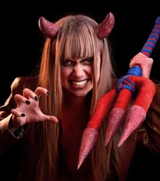 Devil girl with a trident on a black background Foto stock
