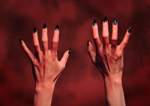 Devil hands on background of fire Stock Photos