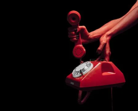 Devil hands with retro phone Stock Photos