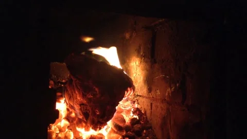 Devil Head Firewood Burns Out with Flame of fire &amp; Coals Smolder in Dark Stove 1 Stock Footage 167971139