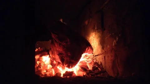 Devil Head Firewood Burns Out with Flame of fire &amp; Coals Smolder in Dark Stove 2 Stock Footage 167971173