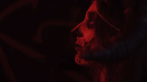 The devil with horns and blood on his lips looks in profile, body painting Stock Footage 88584259