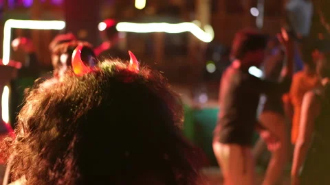 Devil horns woman dance at hell party. Halloween costume fest. Night club life. Stock Footage 240073463