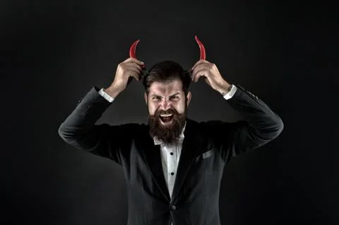 Devil inside. Hot as hell. Handsome macho likes spicy taste. Man hold pepper Stock Photos