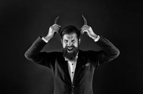 Devil inside. Hot as hell. Handsome macho likes spicy taste. Man hold pepper Stock Photos