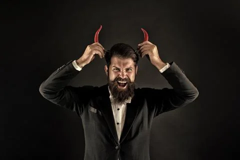 Devil inside. Hot as hell. Handsome macho likes spicy taste. Man hold pepper Stock Photos