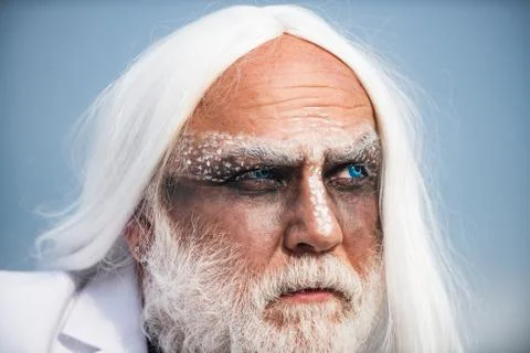 Devil man with angry face with Halloween make up. Devil in wicked witch hat Stock Photos