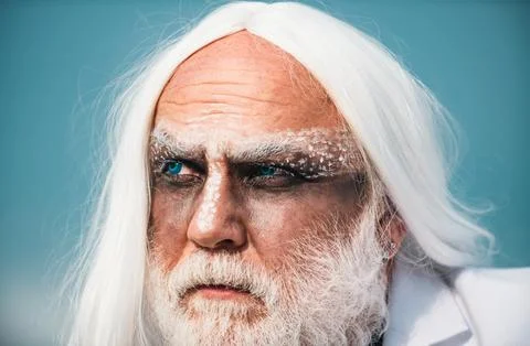 Devil man with angry face with Halloween make up. Devil in wicked witch hat Foto stock