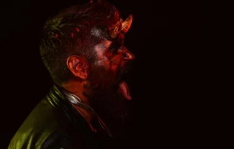 Devil man with bloody eyes. Design for Halloween banner. Halloween bearded man Stock Photos