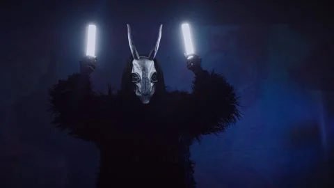 The devil monster dances. A mystical man in a scary mask in a dark studio. Stock Footage 266566445