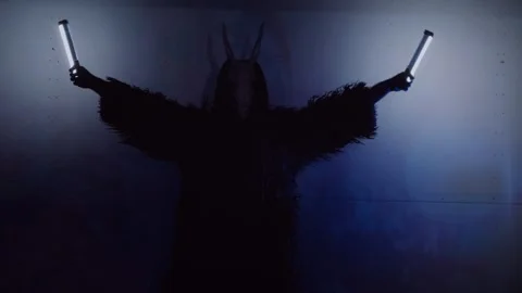 The devil monster dances. A mystical man in a scary mask in a dark studio. Stock Footage 266566448