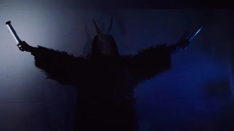 The devil monster dances. A mystical man in a scary mask in a dark studio. Stock Footage 266566460