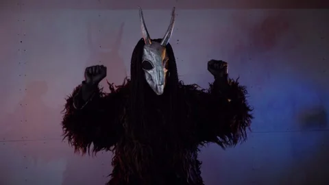 The devil monster dances. A mystical man in a scary mask in a dark studio. Stock Footage 268480782
