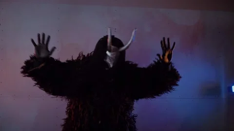 The devil monster dances. A mystical man in a scary mask in a dark studio. Stock Footage 268480783