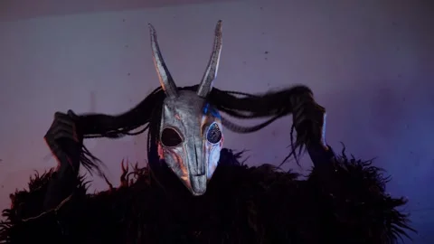 The devil monster dances. A mystical man in a scary mask in a dark studio. Stock Footage 268481037