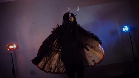 The devil monster dances. A mystical man in a scary mask in a dark studio. Stock Footage 268481057