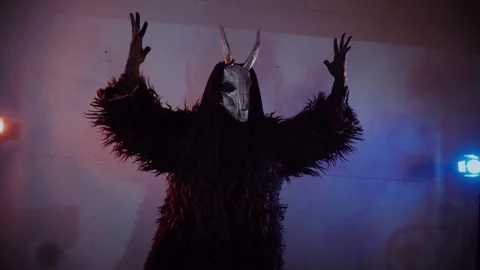 The devil monster dances. A mystical man in a scary mask in a dark studio. Stock Footage 268481083