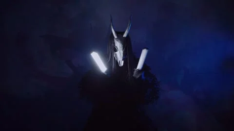 The devil monster dances with RGB sticks in his hands. A man in a scary mask Stock Footage 266919950