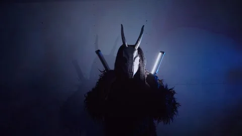 The devil monster dances with RGB sticks in his hands. A man in a scary mask Stock Footage 266920071