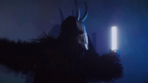 The devil monster dances with RGB sticks in his hands. A man in a scary mask Stock Footage 266920085