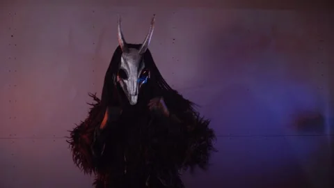 The devil monster dances with RGB sticks in his hands. man in a scary mask Stock Footage 266928040
