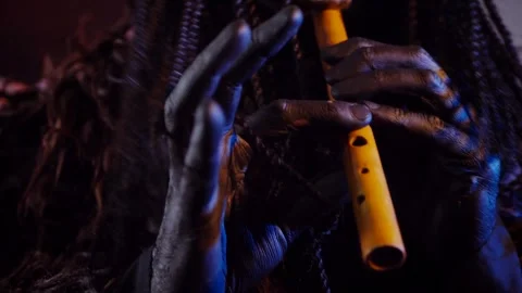 The devil monster plays the flute. A mystical man in a scary mask Stock Footage 268481096