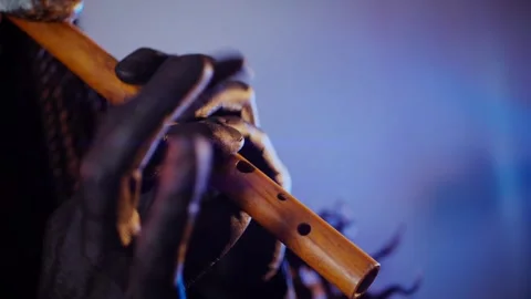 The devil monster plays the flute. A mystical man in a scary mask Stock Footage 268481181
