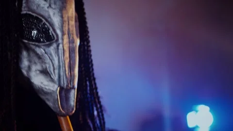 The devil monster plays the flute. A mystical man in a scary mask Stock Footage 268481184